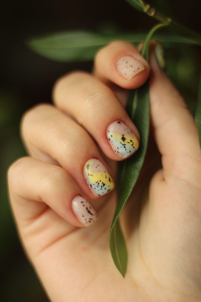 Creative nail art with colorful speckled manicure design
