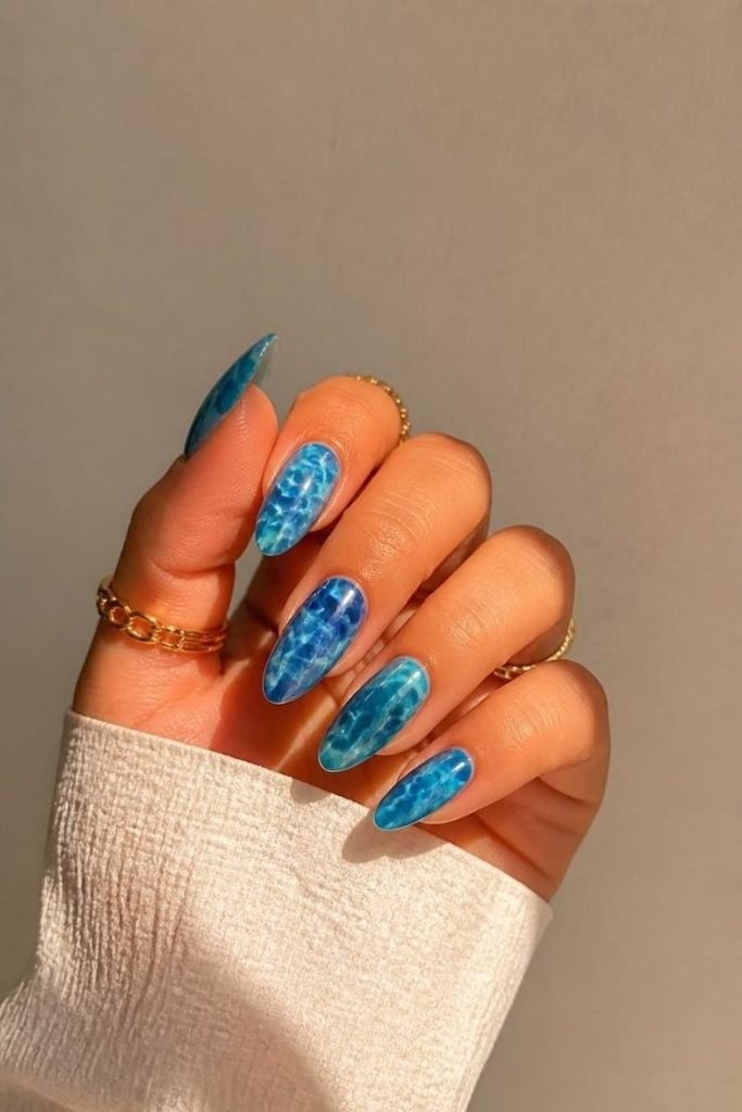 29 Pool Party Nails 2026: Fun, Colorful Designs for Summer Vibes ocean-blue-ripple-nails